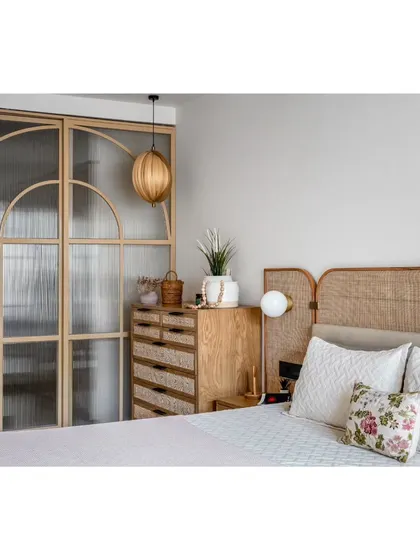 Another view of the master bedroom, highlighting the custom fluted glass wardrobe and the natural textures that make the space feel so calming.