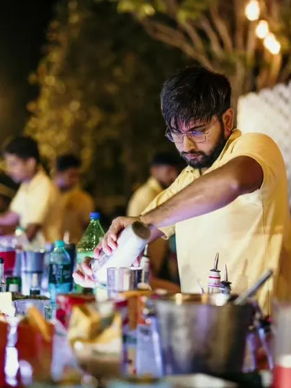 Two of our bartenders focused on their craft, pouring and mixing drinks for a busy event. Their concentration and skill ensure every cocktail is made to perfection.