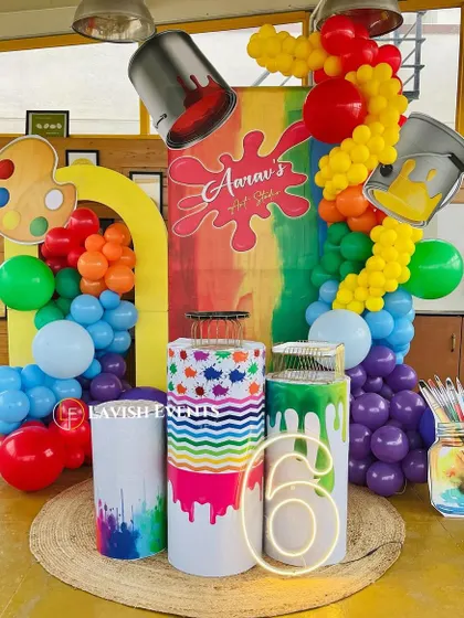 Another angle of the art studio theme, showcasing the creative props like paint palettes, brushes, and overflowing paint cans.