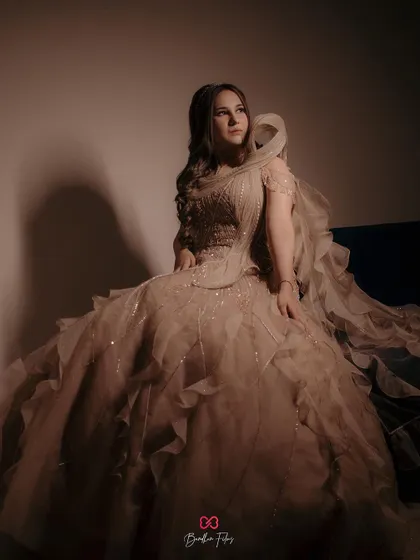 A stunning solo portrait of the bride-to-be in her magnificent gown, captured with dramatic lighting to create an editorial feel.