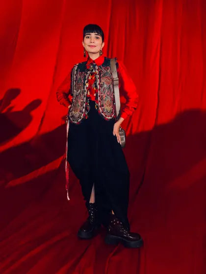 The full look for couture week, pairing a traditional embroidered vest with modern dhoti pants and combat boots.