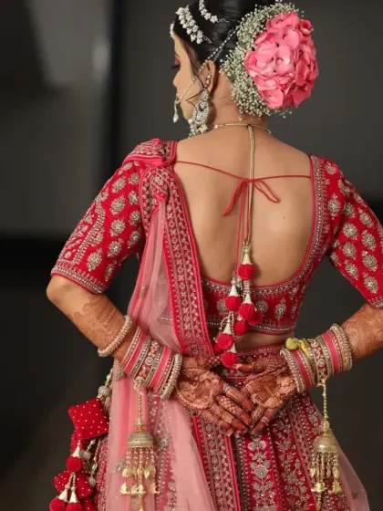 This stunning bride in her red lehenga is a perfect example of a classic North Indian bridal look. We focused on radiant skin, bold eyes, and a traditional bridal bun adorned with flowers.