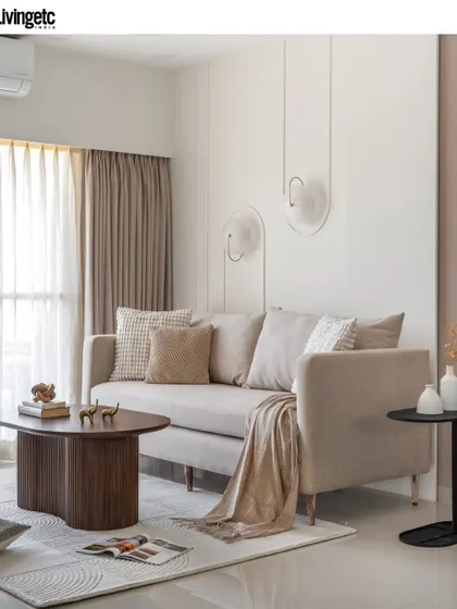 This living room, featured in Livingetc, showcases my clean, modern aesthetic. The design uses a neutral sofa, unique wall sconces, and a sculptural coffee table to create a look of effortless, understated luxury.