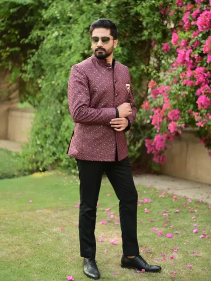 Our wine-colored Jodhpuri suit, shown in an outdoor setting. The rich fabric and sharp tailoring make it a standout piece for any formal event.
