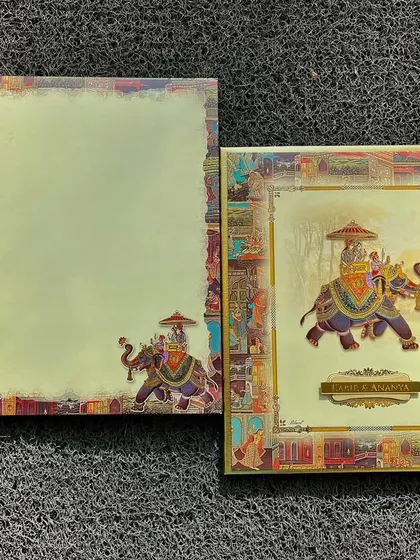 A regal invitation featuring a majestic elephant at the center. The borders are adorned with intricate patterns inspired by traditional Indian art.