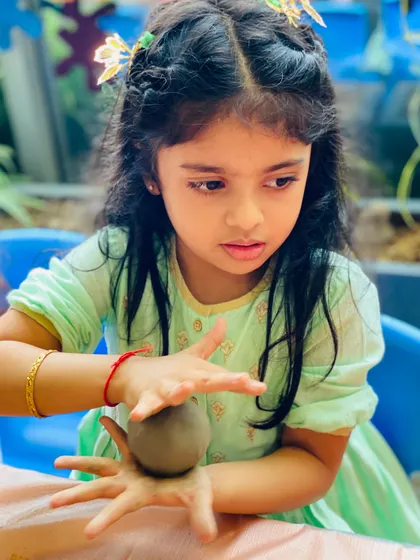 Another little artist deeply focused on her work. Our workshops provide a calm and supportive environment for children to explore their creativity.