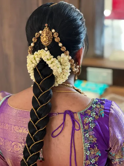 A classic bridal braid, woven with gold thread and adorned with jasmine flowers. This is a timeless hairstyle that is always in demand, and a valuable skill for any bridal artist.