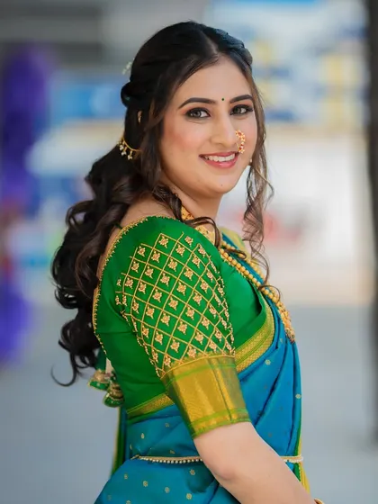 A happy and confident bride-to-be. The half-up, half-down hairstyle with soft curls is a popular and beautiful choice for engagement ceremonies.