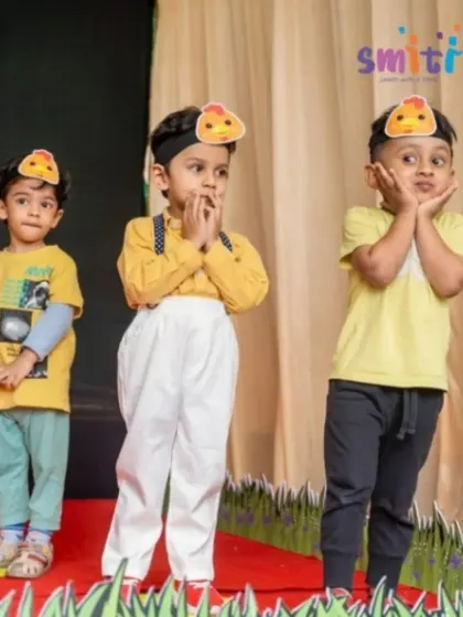 Three boys in adorable chick costumes perform a playful dance on stage. Our themed performances spark imagination and creativity.