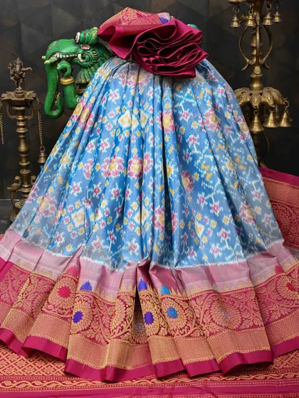 A beautiful light blue Patola silk saree with multi-colored Ikkat work. The intricate patterns and rich border make it a true work of art.