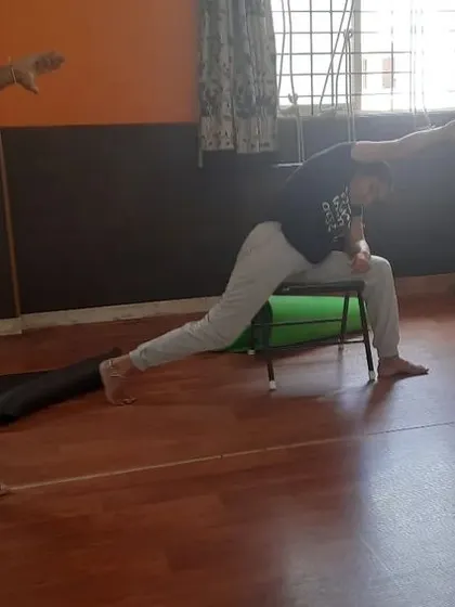 In this variation of a supported side-angle lunge, the chair helps maintain the foundation of the pose. This allows the student to focus on the upper body twist and stretch, opening the chest and shoulders.