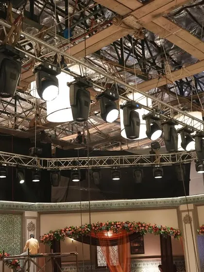 The overhead lighting grid for the 'Deva' set, showing a mix of intelligent lights and practicals like lanterns and chandeliers.