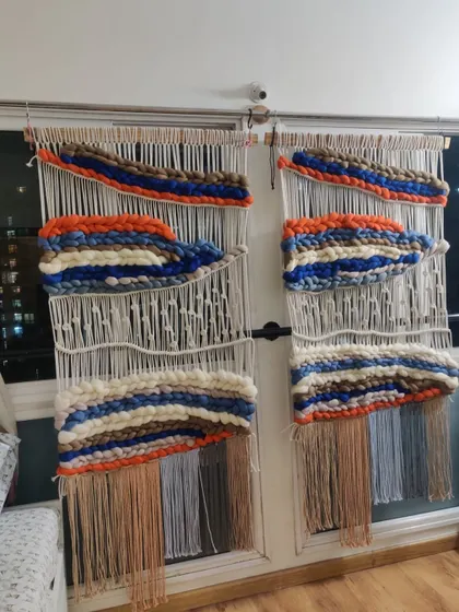 Another view of the custom macra-weaving set, showing the beautiful blend of orange, blue, and neutral tones.