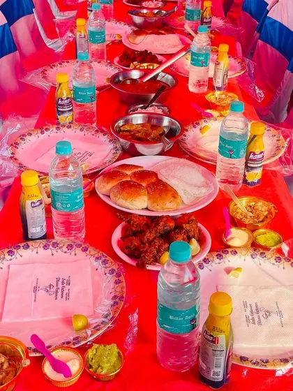 A table set for a feast, complete with our branded napkins. We serve a variety of dishes including fried chicken, buns, and multiple desserts to cater to every taste.