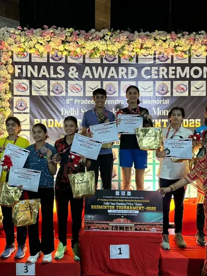 The girls' team proudly displaying their medals and certificates at the Delhi State award ceremony. Their dedication during training sessions is clear to see.