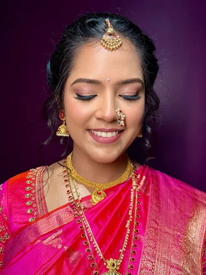 A close-up of the eye makeup. I used soft, neutral tones with a hint of shimmer to make her eyes sparkle, complementing her pink saree beautifully.