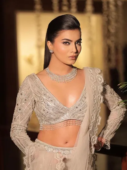 A full-length view of this stunning silver-grey lehenga. The intricate beadwork and modern blouse design make it a perfect choice for a contemporary reception or engagement party.