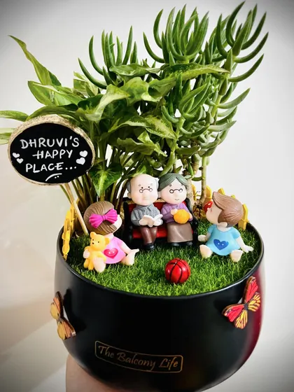 This one is so special to me. It was a gift for a toddler from her grandparents, showing them all together in their happy place. I love creating these little scenes that capture so much love in a beautiful succulent garden.