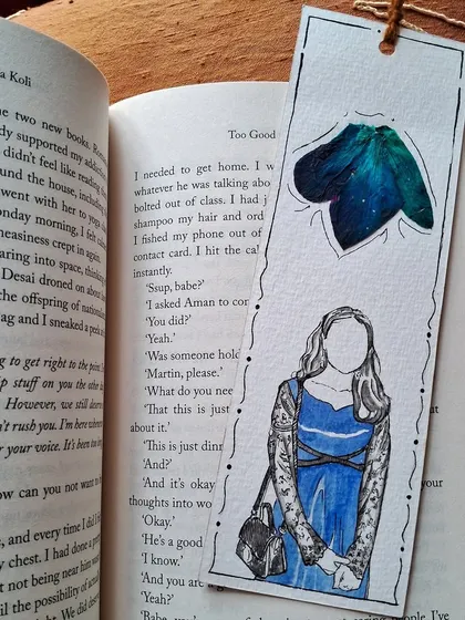 The back of a custom bookmark, showing a simple illustration of a person with a pop of color. Even the back can tell a part of the story.