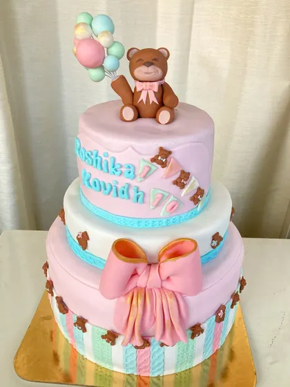 Another view of the joint birthday teddy bear cake, showing the teddy holding a bunch of balloons.