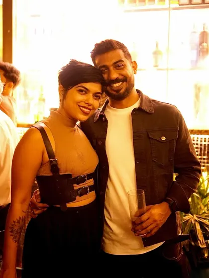 A stylish couple posing for a photo at my debut gig at Pangeo.