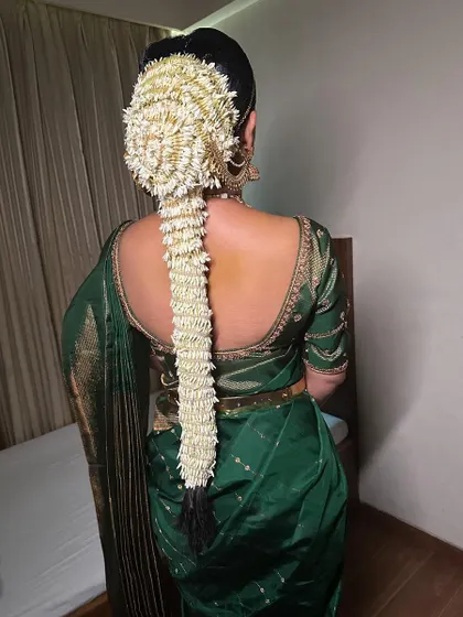 Another beautiful example of a South Indian bridal hairstyle, with a long braid completely covered in jasmine flowers. This look is both traditional and incredibly fragrant.