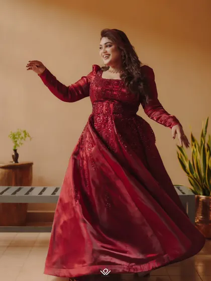 A joyful bride in a flowing red gown, captured mid-dance.