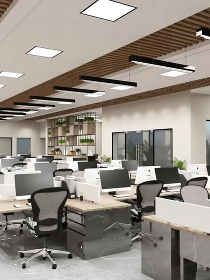 Another view of the Gurgaon office concept, showing the expansive open-plan layout. The ceiling design incorporates both panel lights and linear fixtures to ensure even, comfortable lighting across the entire workspace.