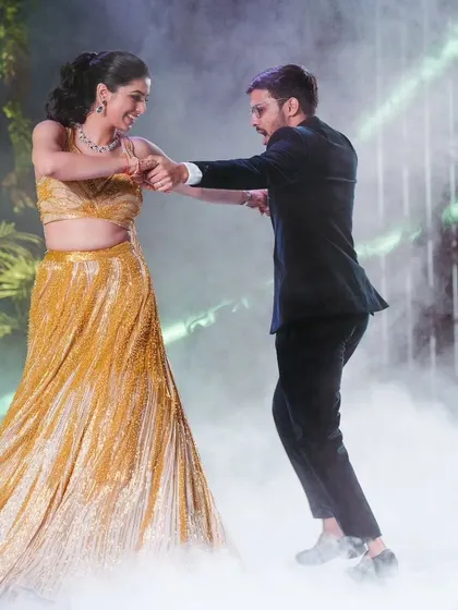 The couple's romantic dance, complete with smoke effects, making it a truly cinematic moment on their Sangeet night.