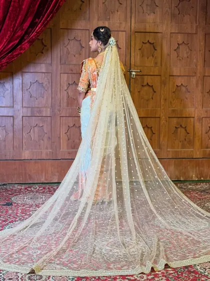 To complete the bridal look, I draped a long, elegant veil over the hairstyle. The sheer, embellished fabric adds a touch of drama and grandeur, perfectly complementing the intricate braid beneath.