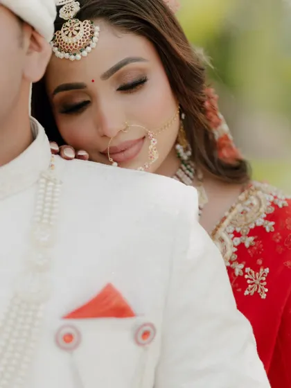 An incredibly tender and intimate moment. The bride rests her head on the groom's shoulder, her eyes closed in a state of peaceful love.