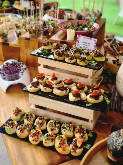 Another angle of our diverse grazing table, showing different styles of bruschetta and canapés. We use multi-level displays to create visual interest and make every item accessible.