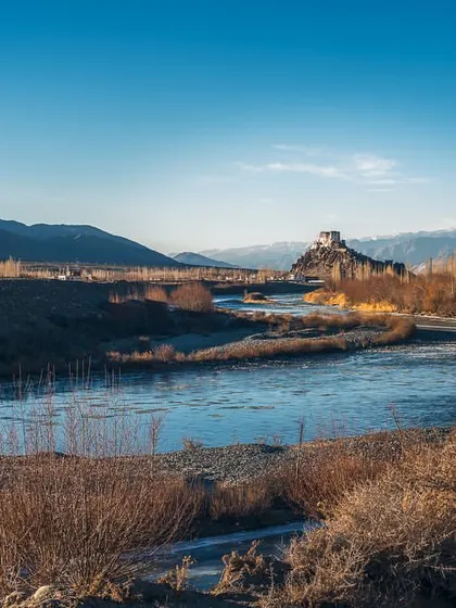 The Stakna Monastery seen from across the Indus River in Ladakh. The winter light and dry landscape create a scene of serene and stark beauty.