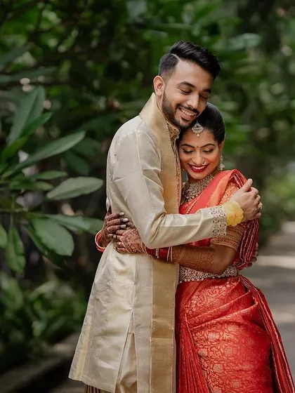 A quiet, intimate portrait framed by lush greenery. We use natural elements to create a sense of romance and tranquility in our couple's wedding photos.