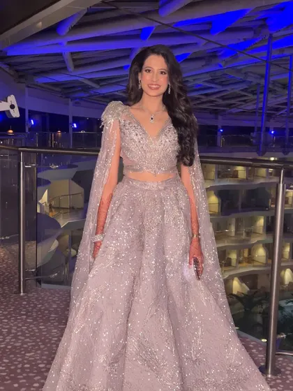 A full-length shot showing how the glamorous makeup and hair complete her stunning silver gown, creating a show-stopping look.