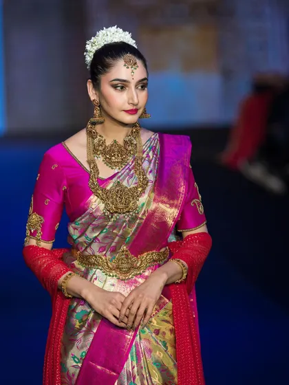 Capturing the energy of the runway for the show stopper at Bangalore Times Fashion Week. This shot highlights the rich colors and textures of the traditional South Indian attire under professional show lighting.