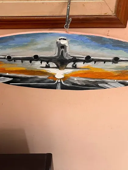 The finished airplane painting, hung and ready to be displayed.