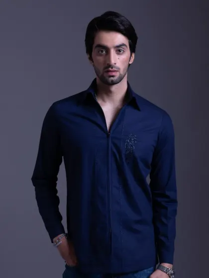 A full view of the navy blue shirt with a zip-front detail. It's a modern and stylish take on a classic piece.