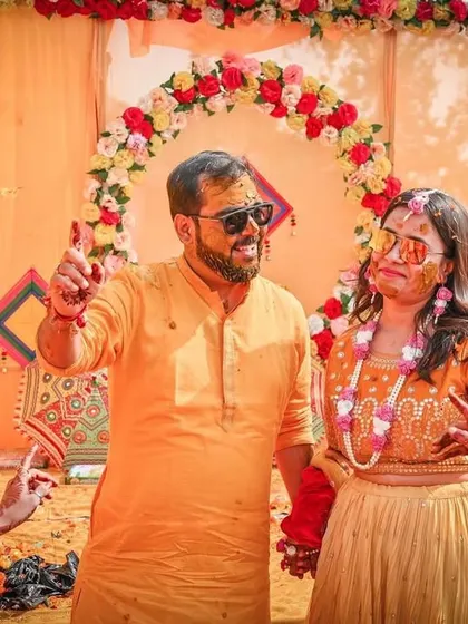 It's all about fun and games. The couple shares a lighthearted moment amidst the colorful decor, showcasing the relaxed and celebratory atmosphere we help create.