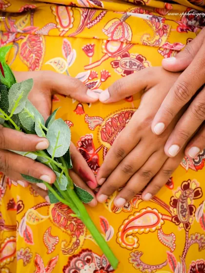 A close-up shot focusing on the hands forming a heart on the baby bump is a classic and symbolic maternity portrait. We use details like this to tell the story of your growing family.