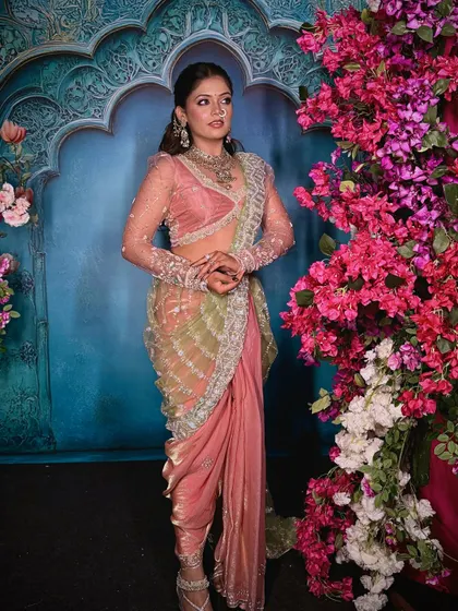 The 'Menka' Nauvari drape from the front. This fusion style combines the structure of a Nauvari with the flow of a modern drape, especially with the sheer dupatta.