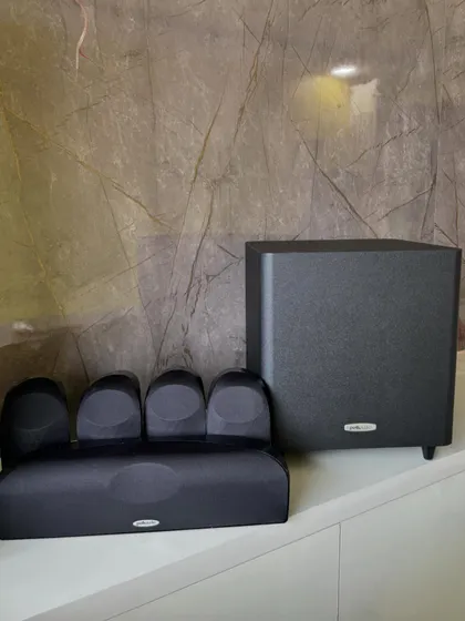 The complete Polk Audio TL1600 package, including four satellite speakers, a center channel, and a powered subwoofer. This is an excellent all in one solution for upgrading your TV sound to a true surround sound system.