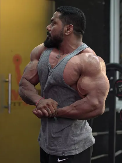 A side chest pose in the gym.