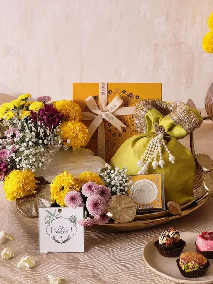 Our Lotus Marigold Tray is a perfect blend of elegance and indulgence for Diwali. It features an Urli candle, truffles, sugar-free mithai, and honey choco almonds, all beautifully arranged on a metal tray.