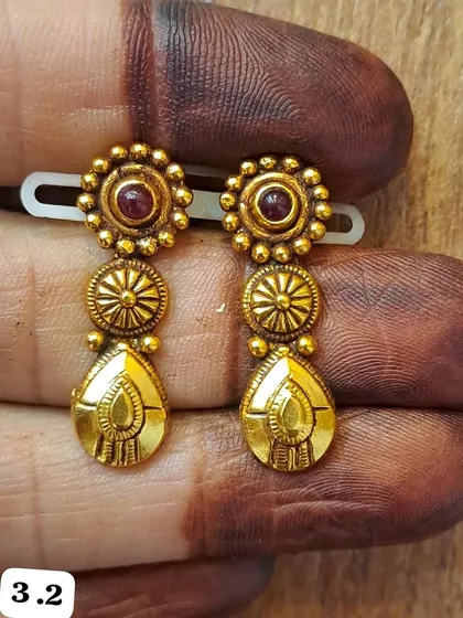 Another design from my antique 92.5 silver, gold-plated earring collection. This piece features a floral stud and a dangling drop element for a touch of movement.