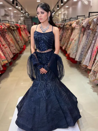 A stunning navy blue fish-cut lehenga with intricate beadwork. This is one of my most popular rental styles for cocktail parties and receptions, perfect for making a statement.