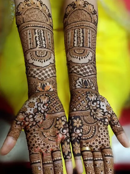 I love how the fine details in this design come together. From the intricate bands on the arm to the floral and paisley work on the hand, every element is carefully placed to create a masterpiece.