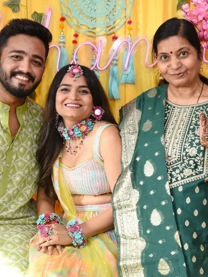The couple with the groom's mother, who shows off her own mehendi design.