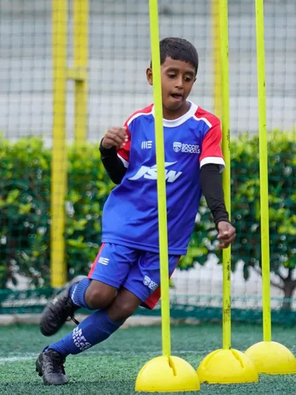 A player weaves through slalom poles, a drill designed to improve agility and close control at speed.