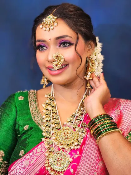 A happy Maharashtrian bride, ready for her wedding. The makeup is bright and joyful, matching her beautiful smile.